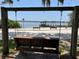 Relax on the beach swing with views of the pier and calm lake waters on a clear day at 9676 Wild Oak Dr, Windermere, FL 34786