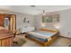 Relaxing bedroom with neutral tones, showcasing a modern platform bed and ample sunlight at 9676 Wild Oak Dr, Windermere, FL 34786