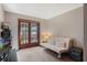Sunlit bedroom with french doors and seating at 9676 Wild Oak Dr, Windermere, FL 34786