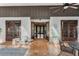 Inviting entryway featuring double wood doors and tiled patio with seating area at 9676 Wild Oak Dr, Windermere, FL 34786