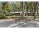 Secluded single-story home surrounded by mature trees and manicured hedges at 9676 Wild Oak Dr, Windermere, FL 34786