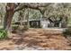 Charming single-story home featuring a lush, wooded landscape with an extended driveway and neutral color palette at 9676 Wild Oak Dr, Windermere, FL 34786