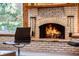 Cozy living room featuring a brick fireplace with seating and natural light at 9676 Wild Oak Dr, Windermere, FL 34786
