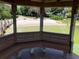 Inside the gazebo looking out on the beach with walkways, benches, and calm lake waters at 9676 Wild Oak Dr, Windermere, FL 34786
