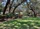 A peaceful park bench nestled among mature trees, lush greenery, and vibrant foliage at 9676 Wild Oak Dr, Windermere, FL 34786
