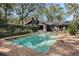 Sparkling backyard pool bordered by brick patio with wooded surroundings and privacy fence at 9676 Wild Oak Dr, Windermere, FL 34786