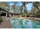 Large pool and brick patio offer a serene backyard with lush surroundings and privacy at 9676 Wild Oak Dr, Windermere, FL 34786