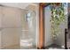 Bright shower with glass door, tiled flooring and an adjacent private courtyard at 9676 Wild Oak Dr, Windermere, FL 34786