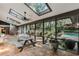 Enclosed sunroom with brick flooring and skylights overlooking the pool and backyard at 9676 Wild Oak Dr, Windermere, FL 34786