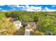 Aerial view of a residential property with a well-kept lawn, driveway, and mature trees at 1002 Kelsey Ave, Oviedo, FL 32765