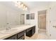 Bathroom featuring double sinks and a shower behind a glass door at 1002 Kelsey Ave, Oviedo, FL 32765