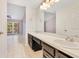 Bathroom featuring double sinks and a view through a windowed doorway at 1002 Kelsey Ave, Oviedo, FL 32765