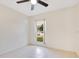 Bedroom featuring a ceiling fan and a window with a view to the yard at 1002 Kelsey Ave, Oviedo, FL 32765