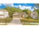 Charming single-Gathering home with a well-manicured lawn, long driveway, and an attached two-car garage at 1002 Kelsey Ave, Oviedo, FL 32765