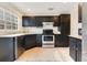 Kitchen featuring stainless steel appliances, granite countertops, and dark cabinets at 1002 Kelsey Ave, Oviedo, FL 32765