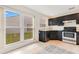 Well-lit kitchen featuring granite countertops, stainless steel appliances and a large window offering exterior views at 1002 Kelsey Ave, Oviedo, FL 32765