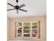 Bright living room featuring a ceiling fan and natural light streaming through large windows at 1002 Kelsey Ave, Oviedo, FL 32765