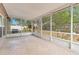 Enclosed porch featuring a stone tile floor and a view of the backyard at 1002 Kelsey Ave, Oviedo, FL 32765