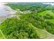 Expansive aerial view of lush landscape with a wooden dock and gazebo near the water at 10176 Hart Branch Cir, Orlando, FL 32832