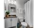 Bathroom featuring neutral-toned cabinets, a dark countertop, and a plant decoration at 10176 Hart Branch Cir, Orlando, FL 32832