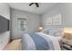 Comfortable bedroom features a ceiling fan, large window, and relaxing light blue bedding at 10176 Hart Branch Cir, Orlando, FL 32832