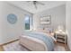 Clean and light bedroom featuring a blue comforter, and a window with a backyard view at 10176 Hart Branch Cir, Orlando, FL 32832