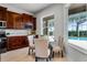 Cozy dining area with dark wood cabinets and windows overlooking the pool at 10176 Hart Branch Cir, Orlando, FL 32832