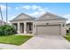 Well-maintained home features a two-car garage, manicured lawn, and inviting curb appeal at 10176 Hart Branch Cir, Orlando, FL 32832