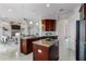 Open kitchen boasts a granite island, updated appliances, and pristine white floors at 10176 Hart Branch Cir, Orlando, FL 32832