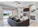 Spacious living room featuring built-in shelving, a ceiling fan, and sliding glass doors at 10176 Hart Branch Cir, Orlando, FL 32832