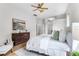 Bright main bedroom featuring a large window and a dark wood dresser at 10176 Hart Branch Cir, Orlando, FL 32832
