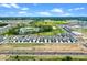 Aerial view of community with a lake, park, and modern residential homes at 13532 Autumn Harvest Ave, Winter Garden, FL 34787