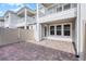 Paver patio with view of surrounding residences and white picket fence at 13532 Autumn Harvest Ave, Winter Garden, FL 34787