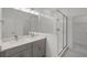 Modern bathroom featuring double vanity with stone countertop, frameless glass shower, and tile flooring at 13532 Autumn Harvest Ave, Winter Garden, FL 34787