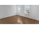 A bright bedroom with natural light and wood-look floors offers a cozy, minimalist space at 13532 Autumn Harvest Ave, Winter Garden, FL 34787