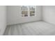 Bright bedroom with plush carpeting and views of the outdoors through two large windows at 13532 Autumn Harvest Ave, Winter Garden, FL 34787