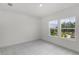Bright bedroom with plush carpeting and views of the outdoors through two large windows at 13532 Autumn Harvest Ave, Winter Garden, FL 34787