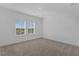 Bright bedroom with carpet floors and two windows offering a view of the outdoors at 13532 Autumn Harvest Ave, Winter Garden, FL 34787
