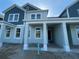 Charming two-story home featuring a covered front porch and a mix of siding textures at 13532 Autumn Harvest Ave, Winter Garden, FL 34787