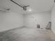 Clean, unfinished two-car garage with garage door and access door to inside of home at 13532 Autumn Harvest Ave, Winter Garden, FL 34787
