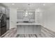 Bright kitchen features gray cabinetry, stainless steel appliances, and a large center island with pendant lighting at 13532 Autumn Harvest Ave, Winter Garden, FL 34787