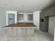 Spacious kitchen featuring gray cabinets, an island, stainless appliances, and ample countertop space at 13532 Autumn Harvest Ave, Winter Garden, FL 34787