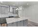 Beautiful kitchen featuring gray cabinets, quartz countertops, a stainless steel hood, and modern backsplash at 13532 Autumn Harvest Ave, Winter Garden, FL 34787