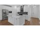 Modern kitchen featuring a large island, stainless steel appliances, and gray backsplash, offering ample space at 13532 Autumn Harvest Ave, Winter Garden, FL 34787