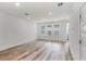 Bright living room featuring hardwood floors, recessed lighting, and three large windows at 13532 Autumn Harvest Ave, Winter Garden, FL 34787