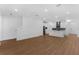 Spacious living area with white walls, sleek flooring, and a view of the modern kitchen at 13532 Autumn Harvest Ave, Winter Garden, FL 34787