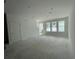 Spacious living room featuring abundant natural light from three large windows, ready for personalization at 13532 Autumn Harvest Ave, Winter Garden, FL 34787