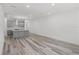 Open-concept living area with hardwood floors and views of the kitchen and neutral walls at 13532 Autumn Harvest Ave, Winter Garden, FL 34787