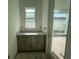 Mud room featuring gray cabinets, countertop space, and a sliding glass door to the patio at 13532 Autumn Harvest Ave, Winter Garden, FL 34787