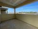 A covered balcony with a view of the lake and greenery provides a relaxing outdoor space at 13817 Luna Harvest Ave, Winter Garden, FL 34787